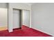 Cozy bedroom featuring sliding mirror closet doors and plush red carpeting at 2622 Rimpacific Cir, Las Vegas, NV 89146