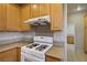 Close up of gas range cooktop with wood cabinets, stainless steel hood and granite countertops at 2622 Rimpacific Cir, Las Vegas, NV 89146