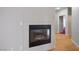Living room fireplace with tile surround and view into adjacent living spaces at 2622 Rimpacific Cir, Las Vegas, NV 89146