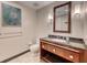 Neutral bathroom with granite countertop, wood cabinetry, decorative light fixtures, and coordinating hardware at 2700 Las Vegas Blvd # 3501, Las Vegas, NV 89109