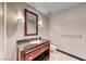 Cozy powder bathroom with granite countertop, wooden cabinet, modern light fixtures, and tile floor at 2700 Las Vegas Blvd # 3501, Las Vegas, NV 89109