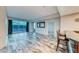Open living area features wood floors, large windows with a city view, and bar seating at 2700 Las Vegas Blvd # 3501, Las Vegas, NV 89109
