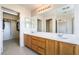 Bathroom with double sinks and a large mirror, offering access to the walk-in closet at 2739 Cramond St, Henderson, NV 89044