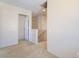 Hallway with carpet leading to a staircase and several doorways at 2739 Cramond St, Henderson, NV 89044
