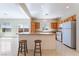 Bright kitchen with stainless steel appliances, tile floor, and center island with seating at 2739 Cramond St, Henderson, NV 89044