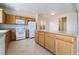 Charming kitchen with wood cabinets, granite counters, an island, and appliances at 2739 Cramond St, Henderson, NV 89044
