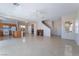 Bright living room with tile floors, an open layout, laundry, and staircase at 2739 Cramond St, Henderson, NV 89044