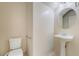 Bright powder room features a pedestal sink, tiled floor, and a round mirror at 2739 Cramond St, Henderson, NV 89044
