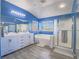 Bright bathroom featuring dual sinks, shower, and a bathtub near a window offering ample natural light at 2743 Peekskill Ave, Henderson, NV 89052