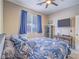 Comfortable bedroom featuring neutral walls, a window view, ceiling fan, and stylish accents at 2743 Peekskill Ave, Henderson, NV 89052