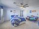 Well-lit bedroom featuring a ceiling fan, carpet floors, large windows, and a queen-size bed with blue covers at 2743 Peekskill Ave, Henderson, NV 89052