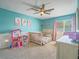 Charming bedroom with a ceiling fan, carpet floors, a crib and lots of space for play and decor at 2743 Peekskill Ave, Henderson, NV 89052