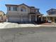 Two-story home featuring a three-car garage and covered front porch at 2743 Peekskill Ave, Henderson, NV 89052