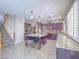 Open kitchen with a large island, stainless steel appliances, and stairs to a second level at 2743 Peekskill Ave, Henderson, NV 89052