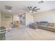 Spacious living room showcasing a staircase, a large grey sofa, and carpet flooring, offering a cozy and inviting atmosphere at 2743 Peekskill Ave, Henderson, NV 89052