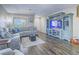 Cozy living room featuring a large sectional sofa, hardwood floors, and a modern entertainment center at 2743 Peekskill Ave, Henderson, NV 89052