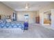 Open main bedroom with vaulted ceilings, soft carpet flooring, a cozy king bed, and an entrance to the main bath at 2743 Peekskill Ave, Henderson, NV 89052