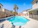 Large swimming pool featuring a waterfall and surrounded by desert landscaping and mature palm trees at 2743 Peekskill Ave, Henderson, NV 89052