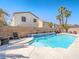 Sparkling swimming pool with a waterfall feature and a desert landscape, ideal for relaxation at 2743 Peekskill Ave, Henderson, NV 89052