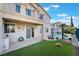 Backyard view with artificial grass, stone table, patio and swimming pool at 2894 Carmelo Dr, Henderson, NV 89052