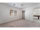 Bedroom with carpet, ceiling fan, shuttered window, closet, and view to a game room at 2894 Carmelo Dr, Henderson, NV 89052