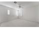 Bright bedroom with white walls, plush carpet, shuttered windows and ceiling fan at 2894 Carmelo Dr, Henderson, NV 89052