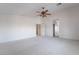 Large bedroom featuring carpet floors, a ceiling fan, and an arched doorway at 2894 Carmelo Dr, Henderson, NV 89052