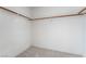 Empty carpeted closet with shelving rods for hanging clothes at 2894 Carmelo Dr, Henderson, NV 89052