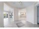 Open entryway showcasing tile flooring and arched openings to the kitchen and dining room, creating an inviting flow at 2894 Carmelo Dr, Henderson, NV 89052