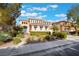 Beautiful two-story home with a tile roof, well-maintained lawn, and shade trees at 2894 Carmelo Dr, Henderson, NV 89052