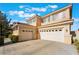 Spacious three-car garage with a paved driveway and well-manicured landscaping at 2894 Carmelo Dr, Henderson, NV 89052