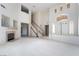 Open-concept living room featuring a fireplace, staircase and soaring ceilings at 2894 Carmelo Dr, Henderson, NV 89052