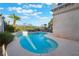 Sparkling pool surrounded by lush landscaping and a decorative fence at 2894 Carmelo Dr, Henderson, NV 89052