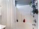 Clean bathroom featuring a shower-tub combo with bright white tiles, shower curtain, and chrome fixtures at 3103 Sunrise Cove Ave, North Las Vegas, NV 89031