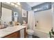 Well-lit bathroom with a vanity, toilet, and shower-tub combination at 3103 Sunrise Cove Ave, North Las Vegas, NV 89031