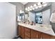 Bathroom featuring dual sinks, a large mirror, and wood-look cabinets, offering style and function at 3103 Sunrise Cove Ave, North Las Vegas, NV 89031