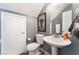 Compact bathroom features a pedestal sink, toilet, and decorative wall art with a neutral color scheme at 3103 Sunrise Cove Ave, North Las Vegas, NV 89031