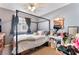 A bedroom featuring a canopy bed, desk, and ample space at 3103 Sunrise Cove Ave, North Las Vegas, NV 89031