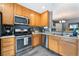 Kitchen with stainless steel appliances, plenty of cabinet space, and a view into the dining area at 3103 Sunrise Cove Ave, North Las Vegas, NV 89031