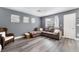 Cozy living room with modern gray walls and stylish gray wood flooring at 3103 Sunrise Cove Ave, North Las Vegas, NV 89031