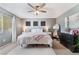 Well-lit main bedroom with ceiling fan, neutral walls, large windows and a decorative pink throw at 3103 Sunrise Cove Ave, North Las Vegas, NV 89031