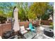 Charming patio with shade umbrella, comfortable seating, and privacy walls, perfect for relaxing outdoors at 3103 Sunrise Cove Ave, North Las Vegas, NV 89031