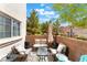 Inviting patio area with stylish furniture, shade umbrella, and brick surround, ideal for outdoor living at 3103 Sunrise Cove Ave, North Las Vegas, NV 89031
