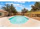 Sparkling community pool featuring a fenced area and lush greenery, perfect for summer relaxation at 3103 Sunrise Cove Ave, North Las Vegas, NV 89031
