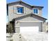 Charming two-story home featuring a gray exterior, two-car garage, and manicured gravel landscaping at 3310 La Cura Ave # Lot 76, Las Vegas, NV 89141