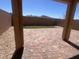 A paved backyard with rock landscaping, artificial grass, and a block wall at 3481 Bradano Ln, Henderson, NV 89044