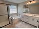 Modern bathroom with glass-enclosed shower, soaking tub, double vanity, and contemporary fixtures at 3481 Bradano Ln, Henderson, NV 89044