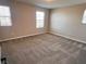 Bright bedroom features neutral carpet, two windows, and neutral colored walls at 3481 Bradano Ln, Henderson, NV 89044