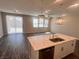Modern kitchen island with marble countertop and sink overlooks the living space at 3481 Bradano Ln, Henderson, NV 89044