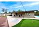 Spacious backyard with patio, built-in grill, putting green, and ample space for activities at 3597 Cochise Ln, Las Vegas, NV 89169